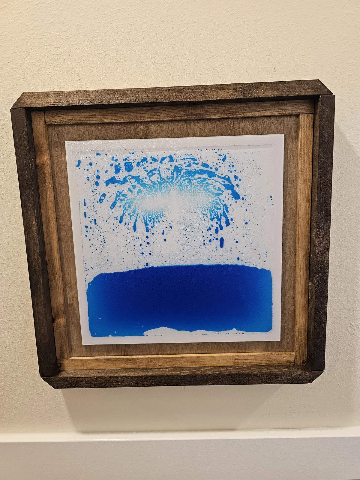 Abstract blue splash painting, a visual sensory station on the hallway wall