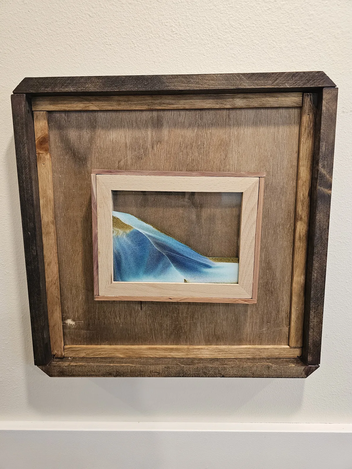 Sand art ocean scene, a calming sensory station on the hallway wall