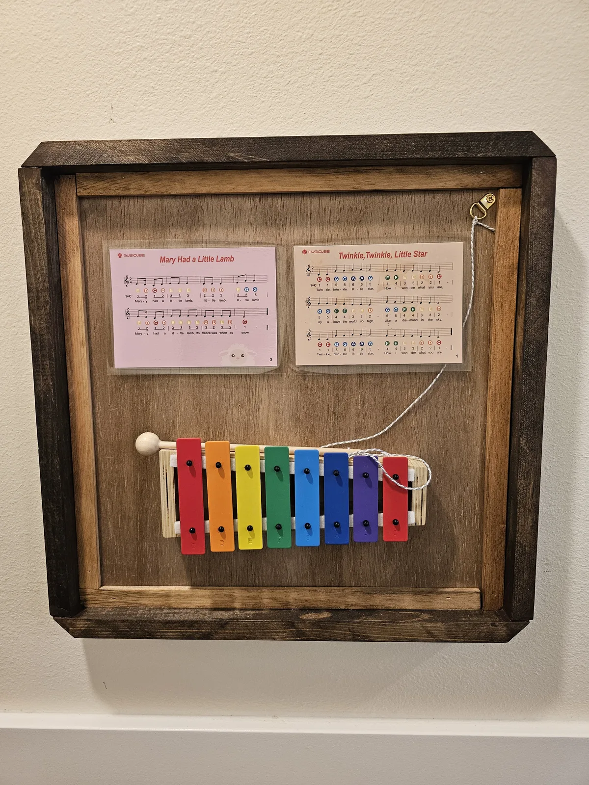 Rainbow xylophone music station with color-coded sheet music for familiar songs, a musical sensory station